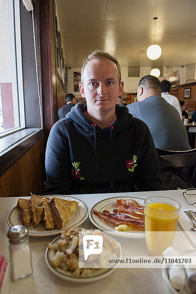 Man eating breakfast in diner