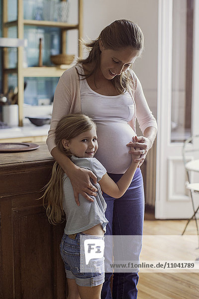 Pregnant woman with young daughter