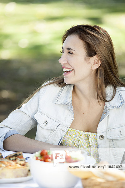 Woman enjoying meal outdoor with friends