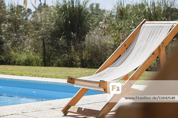 Deckchair beside swimming pool