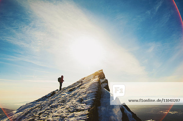 Man hiking on mountain in winter