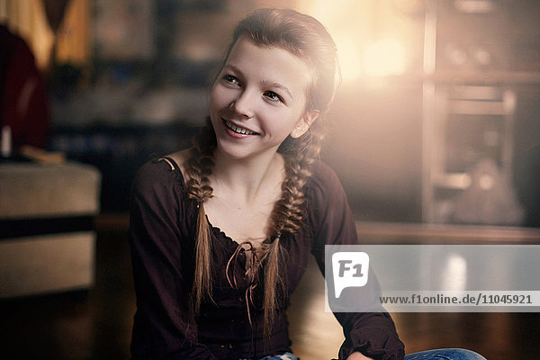 Caucasian teenage girl smiling indoors