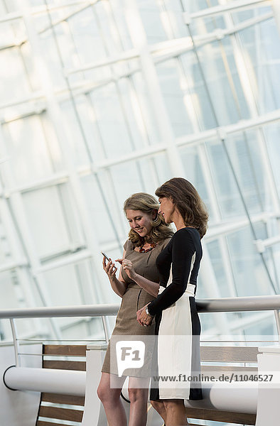 Caucasian businesswomen using cell phone