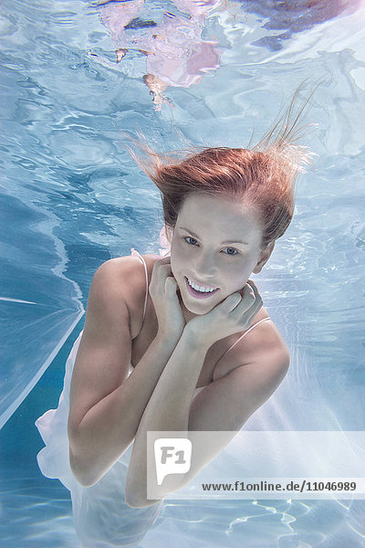 Caucasian woman posing in pool