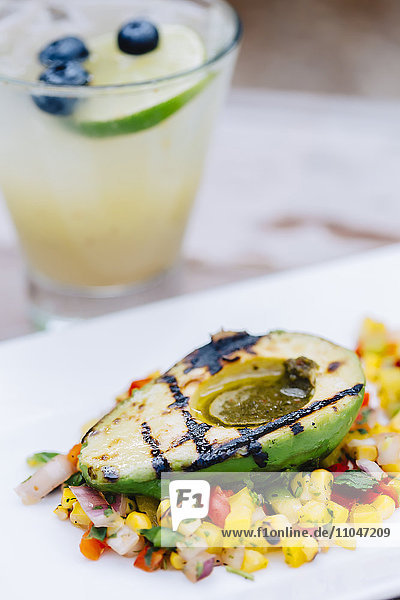 Close up of grilled avocado and salad