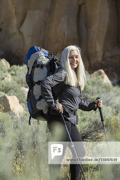 Older Caucasian woman hiking with backpack