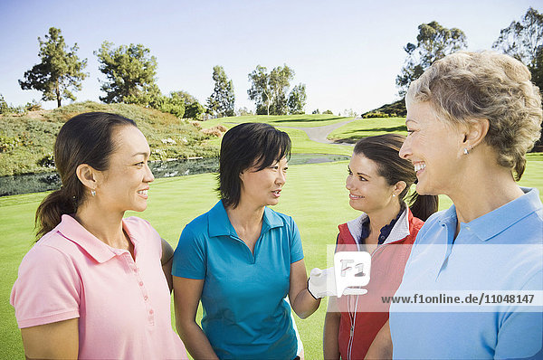 Women talking on golf course
