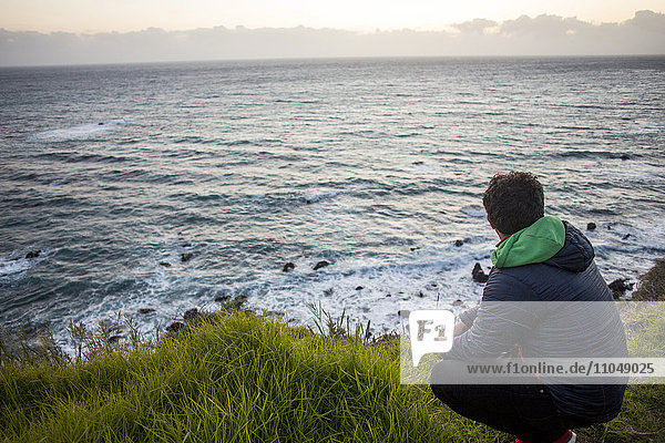 Caucasian man admiring ocean horizon