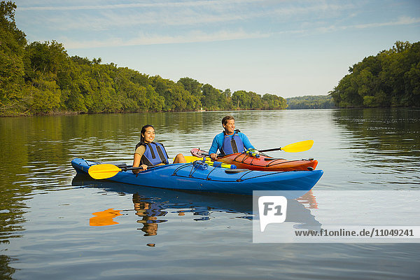 Couple kayaking in river