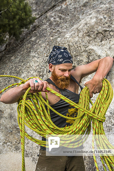 Caucasian man winding rope
