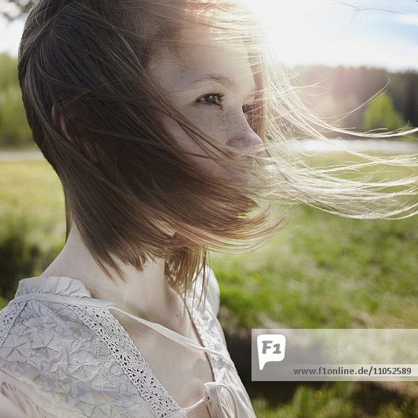 Caucasian girl with hair blowing in wind