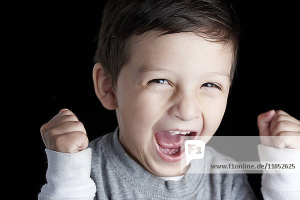 Close up of Hispanic boy cheering
