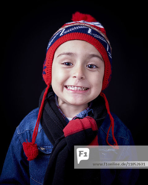 Close up of Hispanic boy wearing warm clothing