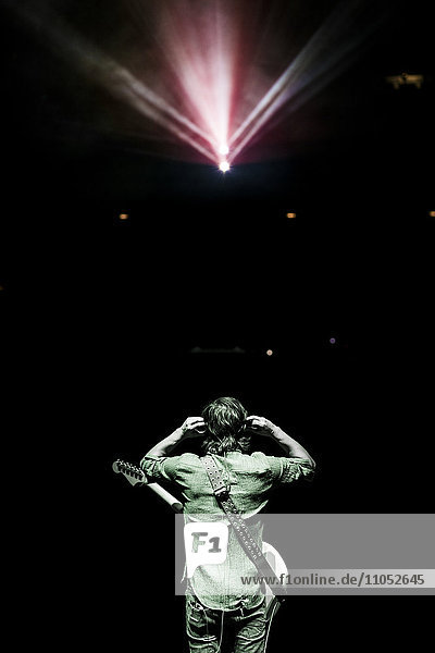 Rear view of musician standing onstage