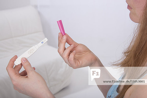Woman looking at pregnancy test.