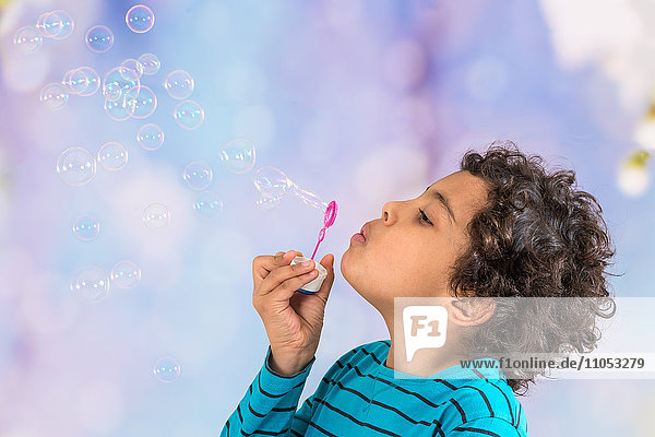 Boy blowing bubbles.