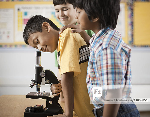 Two children using a microscope.