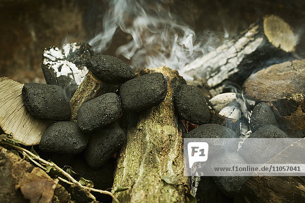 Close up of charcoal briquettes on a barbecue.