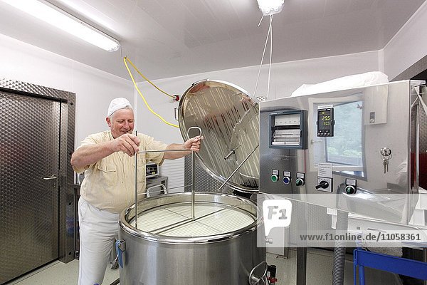 Cheesemaker during the production of goat cheese at the Goas-Alm cheese factory  Goas-Alm  Mittenwald  Upper Bavaria  Bavaria  Germany  Europe