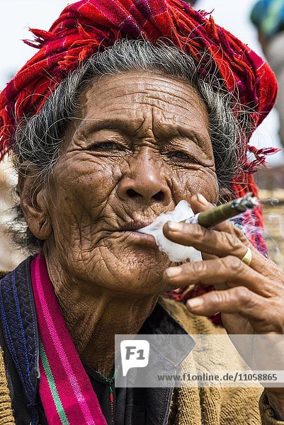 Smoking old woman from the Pao hilltribe or mountain people portrait market Kalaw Shan State Myanmar Burma Asia