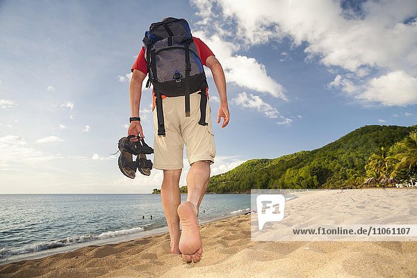 Man walking on the beach  barefooted  beach walking  Grande Anse  Guadeloupe  Lesser Antilles  Caribbean  North America