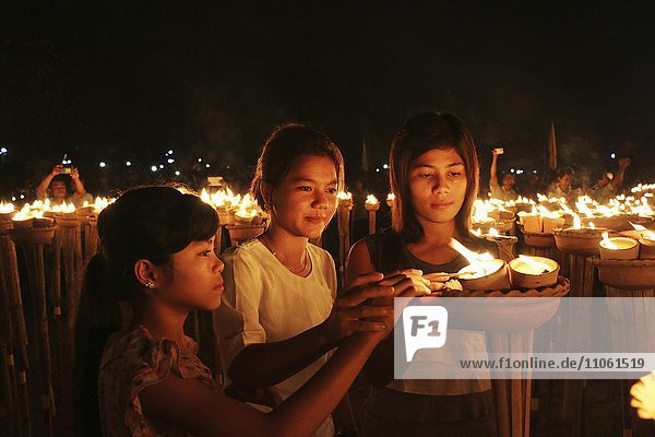 Young women at the lights ceremony  World Peace Festival of the Dhammakaya Foundation  Dawei  Tanintharyi Region  Myanmar  Asia *** IMPORTANT: Image may not be used in a negative context with the Dhammakaya temple ***