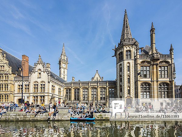 Leie River and promenade on the Graslei  with old guild houses and old post office  young people on the shore  Ghent  Flanders  Belgium  Europe