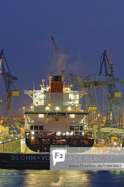 Container ship in the floating dock of Blohm and Voss  Hamburg harbor at night  Hamburg  Germany  Europe