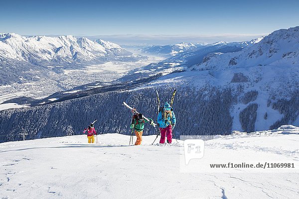 Skiers  freeriders during the ascent with view of the Inntal valley and Innsbruck  Axamer Lizum  Innsbruck  Tyrol  Austria  Europe