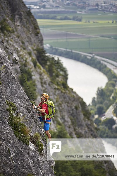 Mountaineer  climber with orange helmet climbing the via ferrata  Zirl  Innsbruck  Tyrol  Austria  Europe