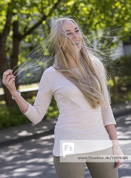 18 year old young woman with blowing long blond hair