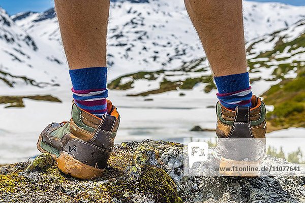 Hiker  hiking boots  socks  behind mountain landscape with snow  Giglachsee  Rohrmoos-Untertal  Obertal  Styria  Austria  Europe
