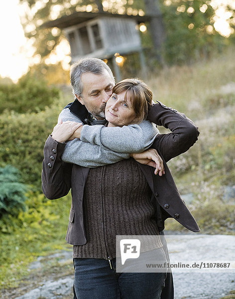 Mature couple embracing outdoors