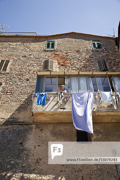 Woman hanging laundry on cloth line