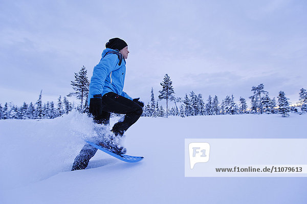 Woman snowshoeing in Winter landscape
