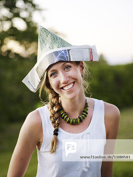 Smiling woman wearing paper hat