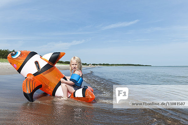 Girl swimming in sea on inflatable toy