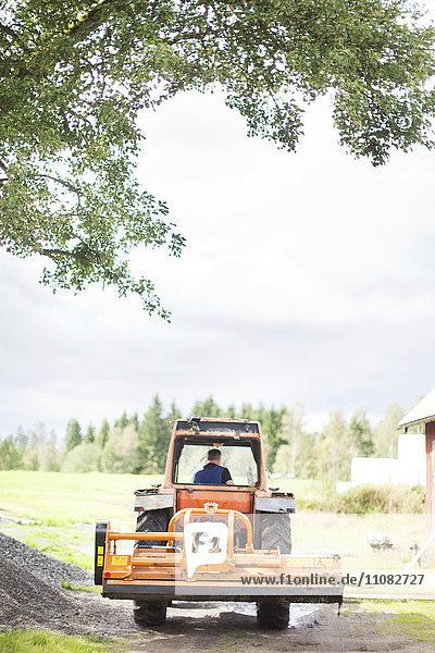 Senior man on tractor Smaland Sweden