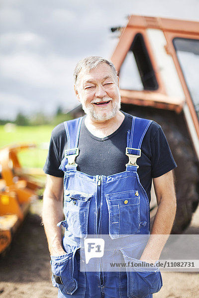 Senior man in front of tractor  Smaland  Sweden