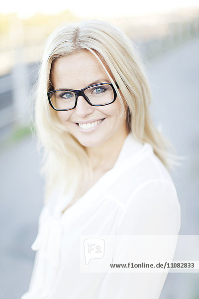 Portrait of young smiling woman wearing glasses