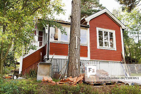 Wooden house with roofing tiles in front  Sweden