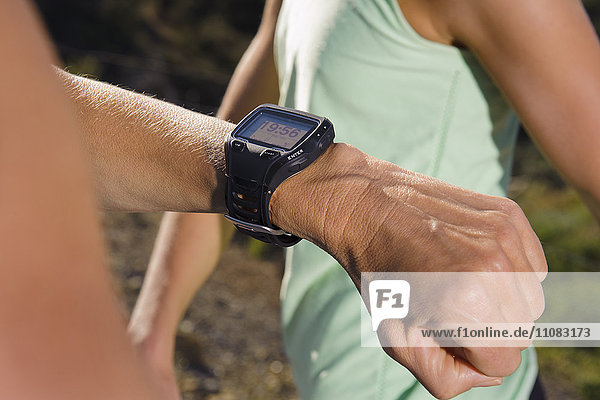 Man checking time and pulse during running  close-up