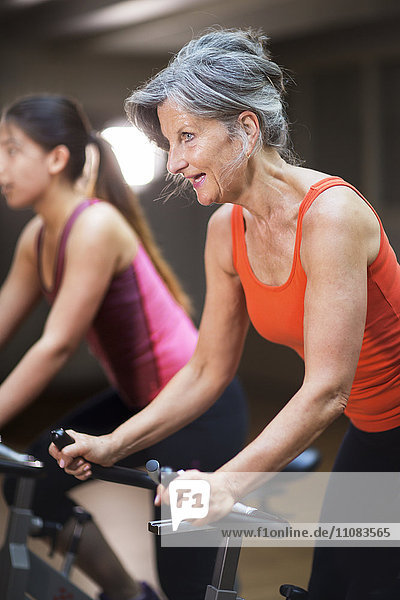 Women riding exercise bikes