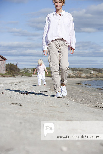 Mother with son walking on beach  Vastkusten  Sweden