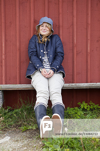Teenage girl against wooden wall  Vastkusten  Sweden