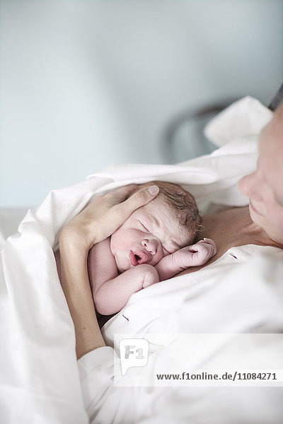 Newborn baby sleeping with mother  Danderyd  Stockholm  Sweden