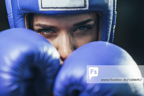 Close-up portrait of confident female boxer