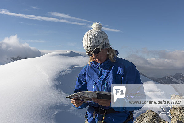 Schweiz  Frau schaut auf Karte bei Bertol Hütte