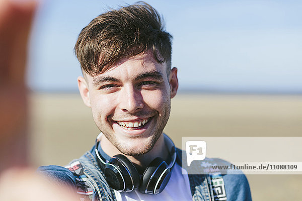 Portrait of smiling young man on the beach