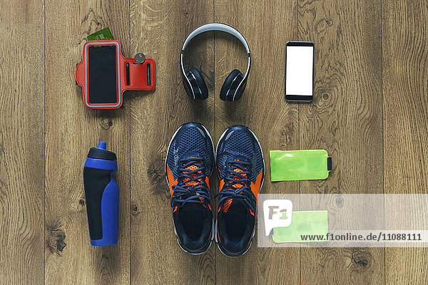 Running shoes  headphones  drinking bottle  smartphone and bags
